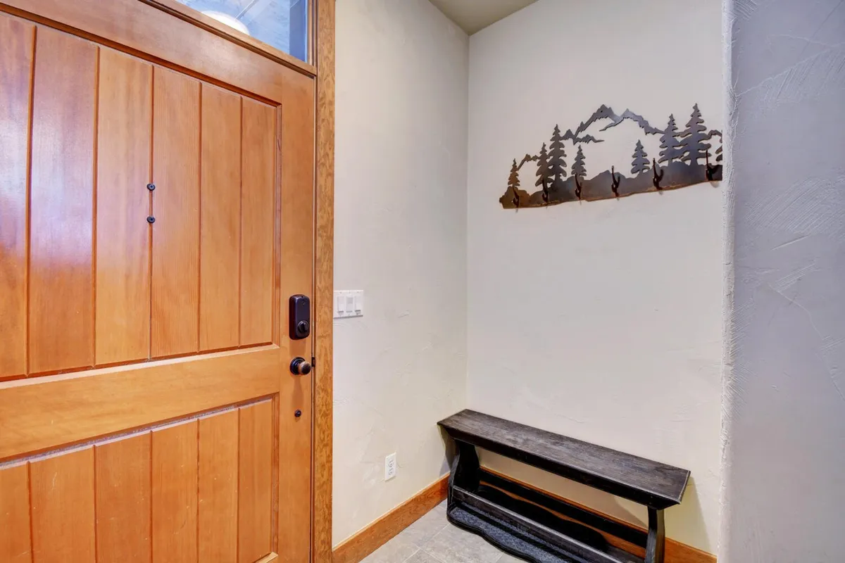 A welcoming view of the villa’s wooden front door, with metal wall art and a bench inviting guests to sit and admire the decor. The entrance sets a tone of hospitality and serves as a transition point between the comfort of the villa and the excitement of local adventures.